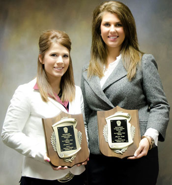 Kassadi Click (left) and Megan Webb standing with their plaques.