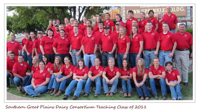 Southern Great Plains Dairy Consortium Teaching class of 2011. Group of people with red shirts and jeans and one person wearing khaki pants.
