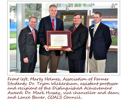 From left, Marty Holmes, Association of Former Students, Dr. Tryon Wickersham, assistant professor and recipient of the Distinguished Achievement Award, Dr. Mark Hussey, vice chancellor and dean and Lance Bauer, COALS Council