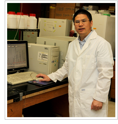 Dr. Guoyao Wu at a computer in his lab