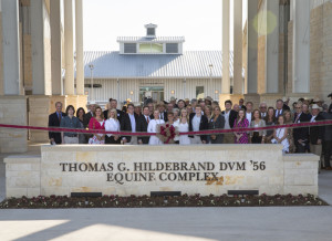 People standing for a ribbon cutting of the Thomas G. Hildebrand DVM '56 Equine Complex.