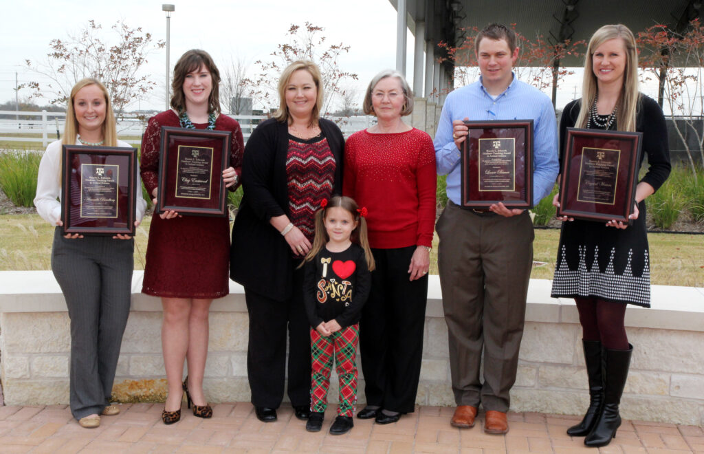 Amanda Bradbery, Clay Eastwood, Cathy Edwards, Sigrid Edwards, granddaughter Claire, Lance Bauer, and Crystal Waters standing while holding their awards.
