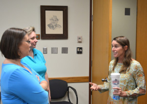 Anne Burkholder talking to two women after a seminar.