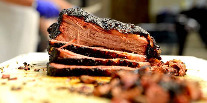 Barbecue brisket with slices in the foreground.