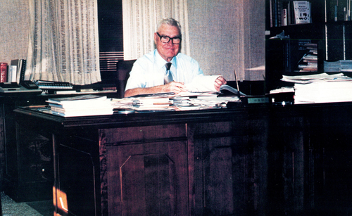 Dr. O.D. Butler sitting at his desk.