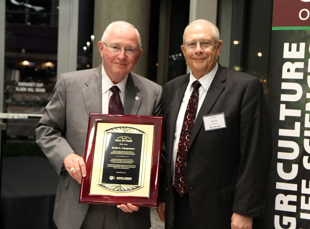 Russell Cross, Ph.D., left, presents Zerle L. Carpenter with a plaque in recognition of Carpenter’s induction into the Animal Science Hall of Fame.