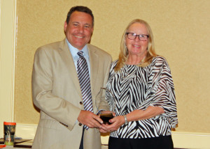 Jason Bruemmer presents the Distinguished Service in Equine Science Award to Dr. Martha Vogelsang.