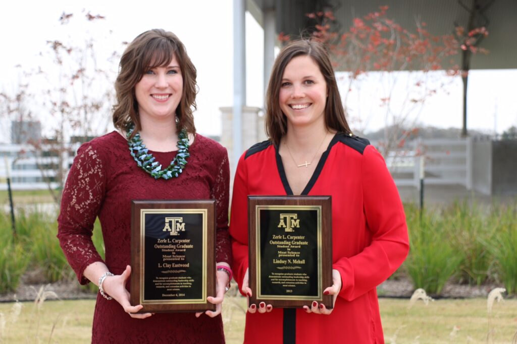 Clay Eastwood, left, and Lindsey Mehall, right, standing wile holding their awards. 