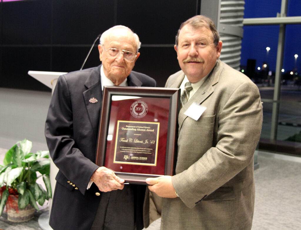 Joe Paschal, Ph.D., right, presents the Animal Science Outstanding Alumni Award to Frank C. Litterst ’43.