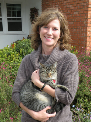 Dr. Mary Anne White holding a striped cat.