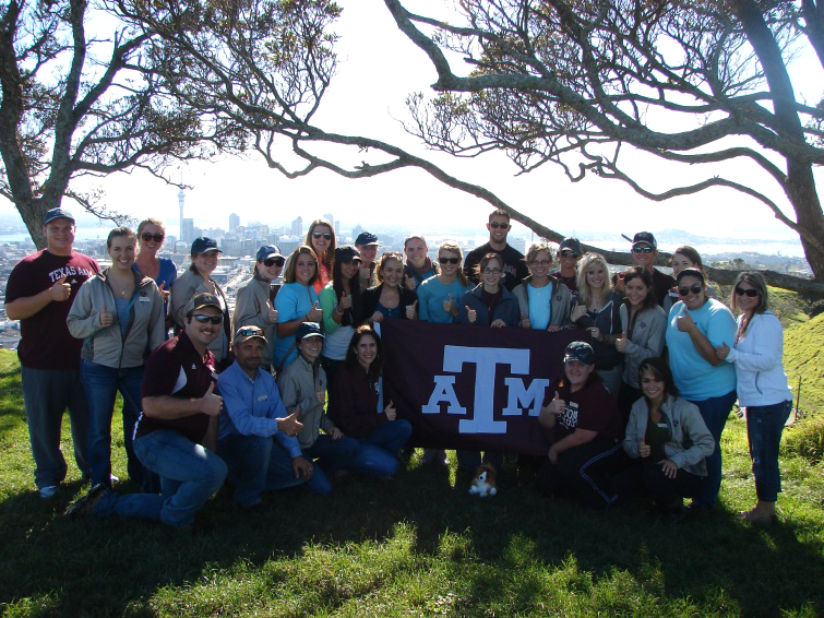 Group of students holding an A&M flag