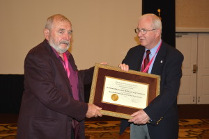 Dr. Kenneth Eng, left, with Russell Cross. Dr. Eng is holding an award.