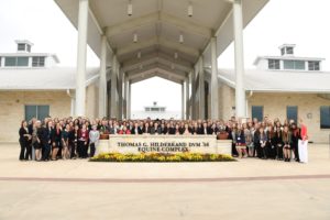 Students standing behind the sign at the Thomas G. Hildebrand Equine Complex.