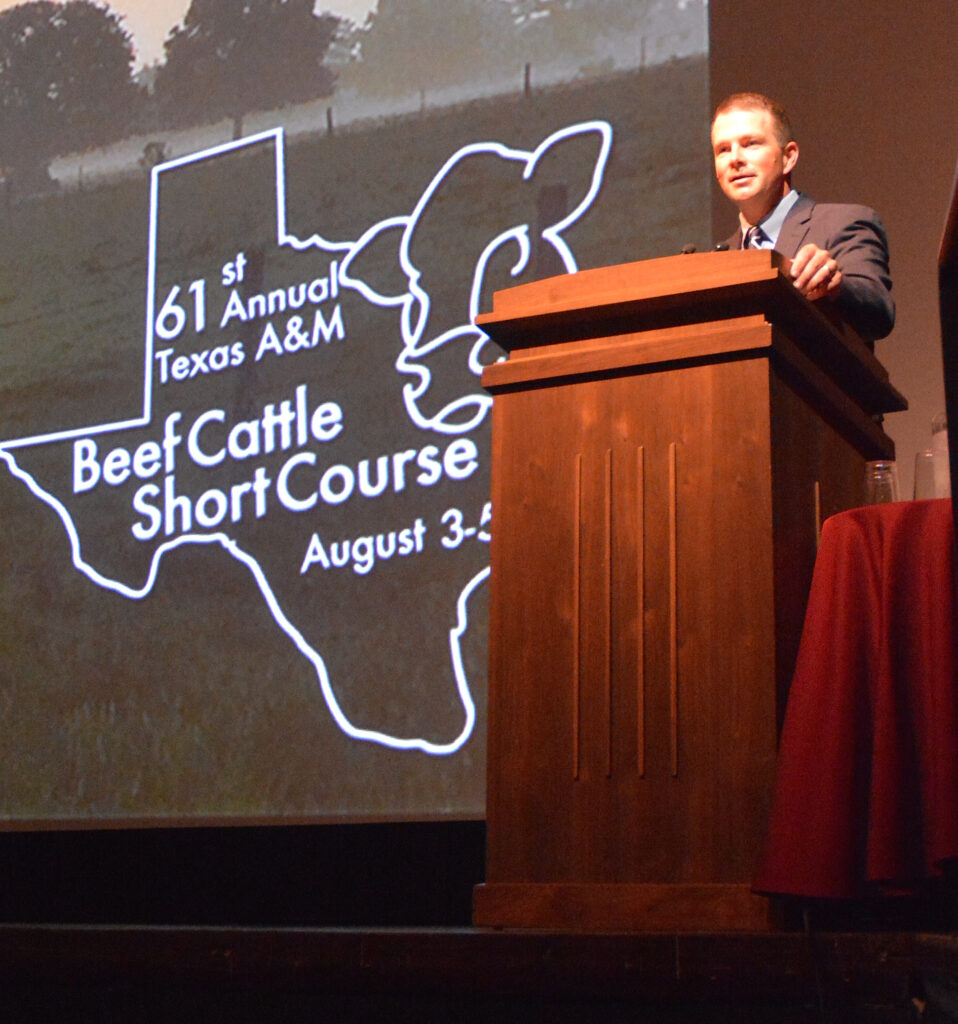 Dr. Jason Cleere standing at the podium during the Beef Cattle Short Course.