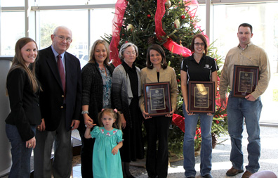 People standing with awards with a tree in the background. From left to right are: Tara Edwards, Dr. Russell Cross, Cathy Edwards, Claire Edwards, Sigrid Edwards, Leslie Frenzel, Ashley Keith and Chase Runyan.