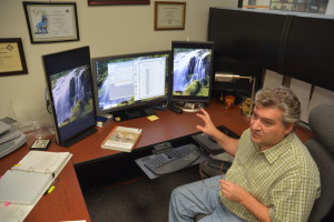 Dr. Luis Tedeschi at his desk with a computer in front of him.