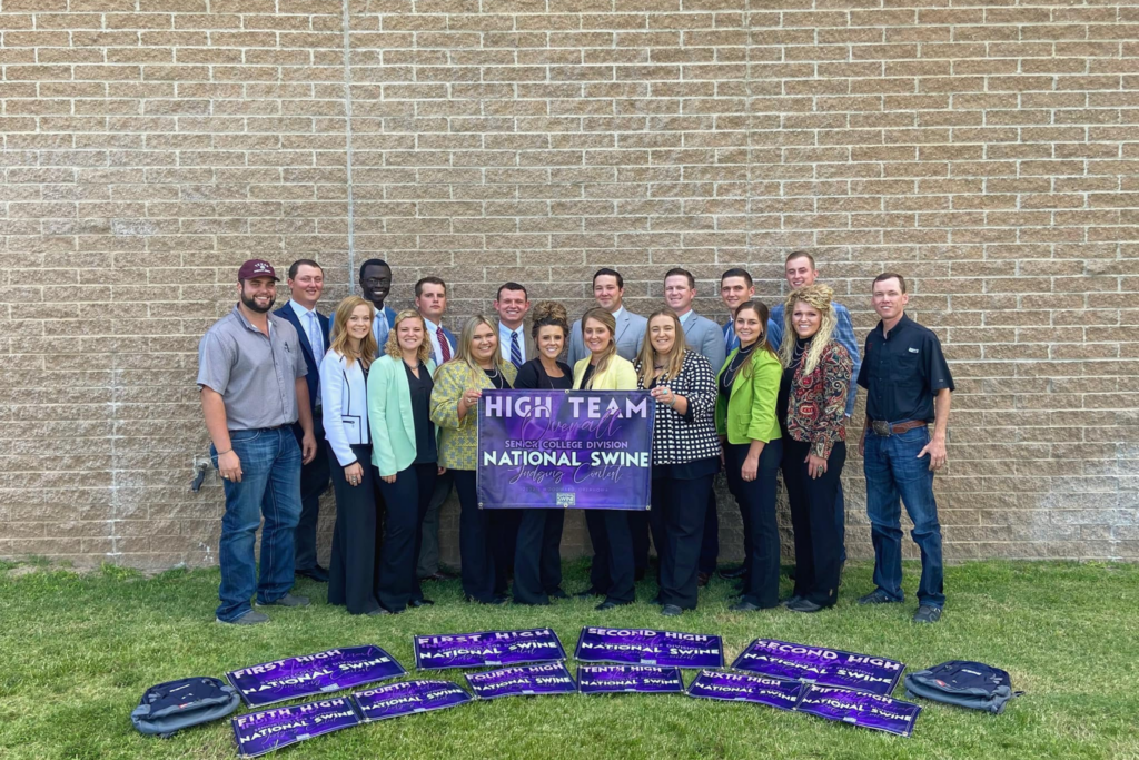 The Livestock Judging team with their award banners surrounding them.