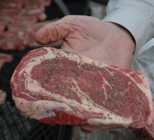 A pieve of meat in someone's hand.