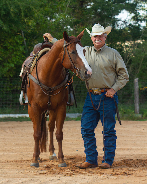 Dr. Doug Householder standing with a horse.