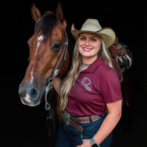 Lauren Orlando standing for a headshot of her and her horse. 