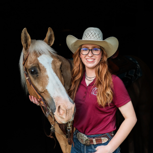 Megan Gajdica standing for a headshot of her and her horse. 