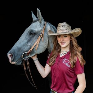 Tristen Drury standing for a headshot of her and her horse. 