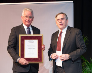 Dr. Stephen Smith & Dr. Craig Nessler, Director, Texas A&M AgriLife Research standing on the stage.