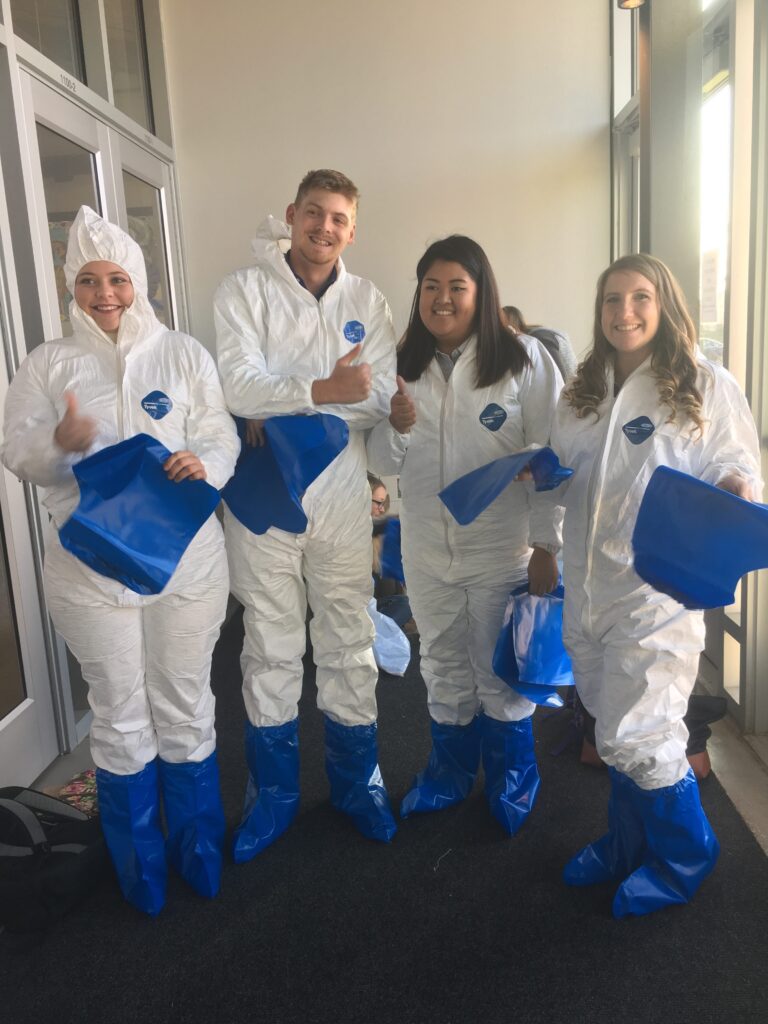 Students dressed in Tyvek protective suits.