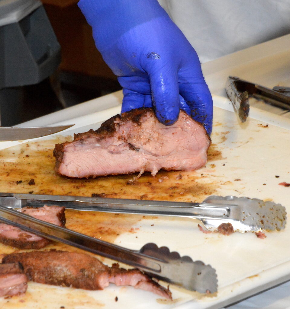 Beef loin being sliced to serve.