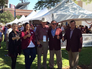 Dr. Charles "Doc" Graham standing with a group of people at a tailgate party.