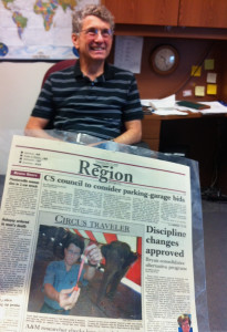Dr. Ted Friend with a newspaper clipping in the foreground.