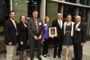 Anne Armstrong’s family & friends standing with Armstrong and her award.