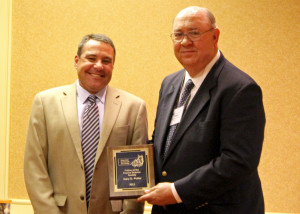 Jason Bruemmer, left, presents the Fellow Award to Dr. Gary Potter.