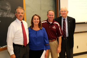 Dr. Bill Dugas, left, acting Vice Chancellor and Dean of Agriculture and Life Sciences, with Kerri Gehring. He was accompanied by Marty Holmes, Association of Former Students, and Dr. Russell Cross, head of animal science, as well as Gehring’s family and graduate students.