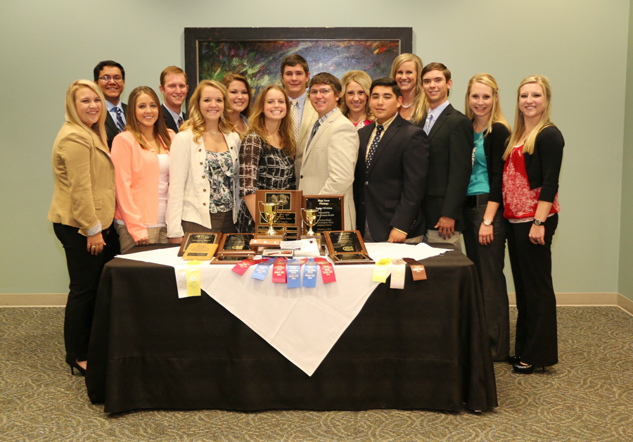 The Meat Judging Team standing behind a table with their awards.