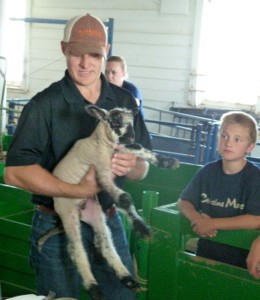 Dr. Reid Redden holding a lamb at a show.