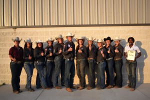 The Stock Horse Team standing for a photo. From left to right are Paige Linne, Anissa Cervera, Ellen Black, Kyla Kalinowski, Madison Crum, Lane Birkenfeld, Morgan Moreno, Haley Birkenfeld, Rachel Sembera, Kylie Reis, Sarah Savage, and Michelle Glover