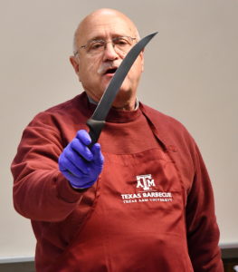 Dr. Jeff Savell demonstrating how to cut brisket.