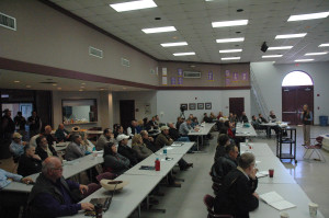 A group of people listening to a presentation in a meeting room