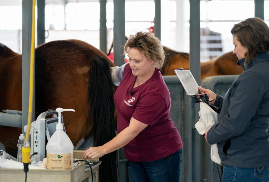 A woman demonstrates a technique while another woman records her.