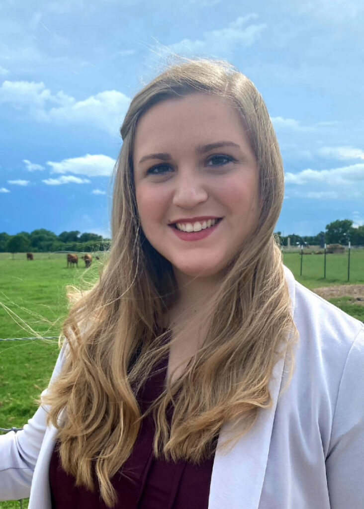 Audrey Earnhardt portrait standing out in a field.