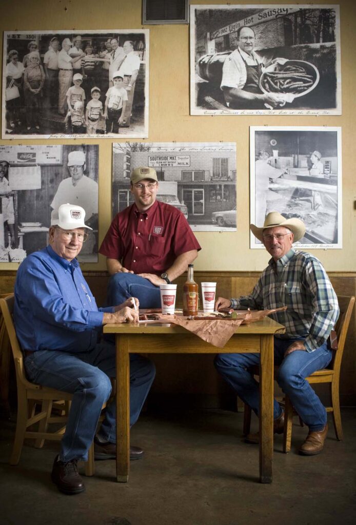 Ernest, Bryan and Billy Bracewell sitting together at a table.