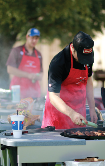 A man slicing barbecue.