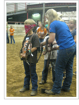 A young participant learning a skill during a demonstration.