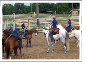People riding horses in an arena during a demonstration.