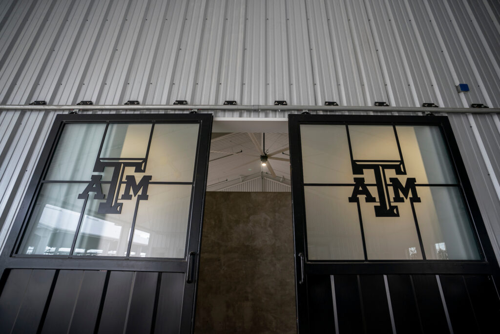 Two doors with the A&M logo on the windows of the doors.