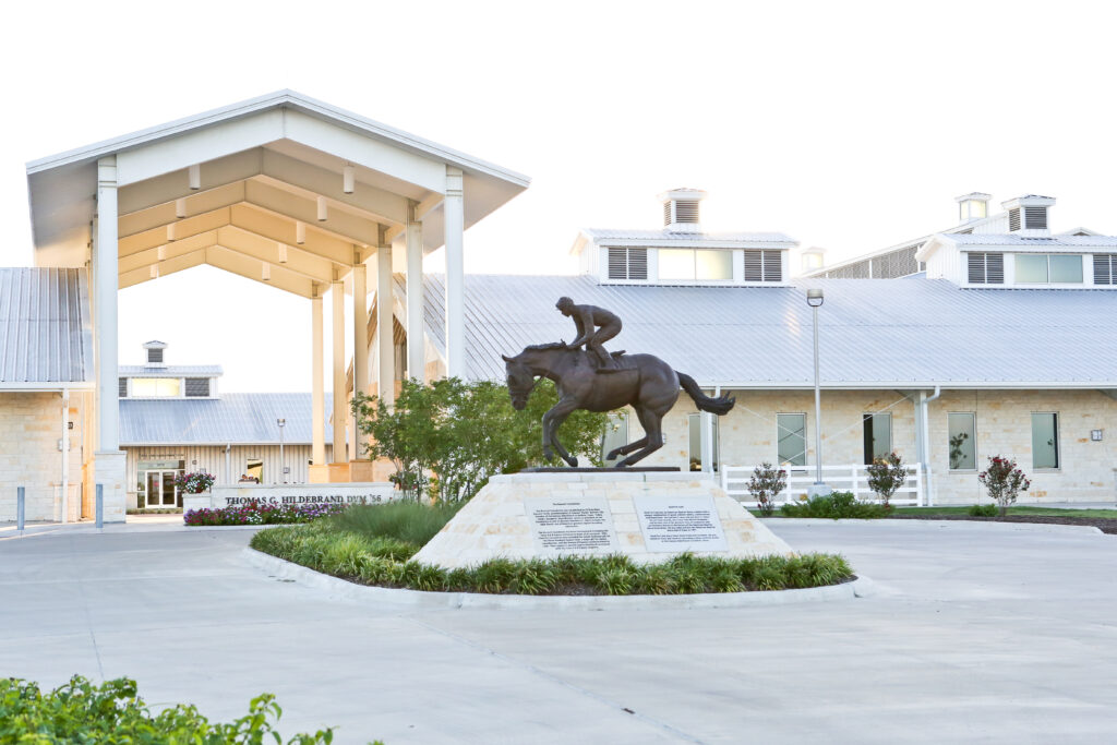 The entrance of The Thomas G. Hildebrand, which has a statue of a man on a horse.