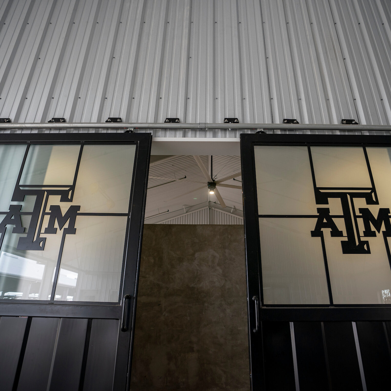 Two doors with the A&M logo on the windows of the doors.