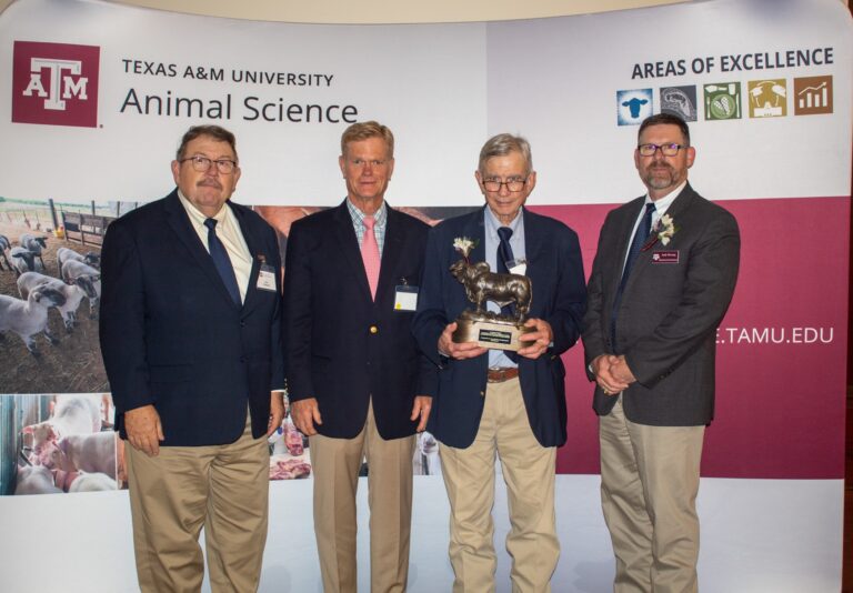 The American Brahman Breeders Association presented a Brahman bull sculpture to Jim Sanders in honor of his service and commitment to the department and the Brahman industry. Presenting the gift at the awards banquet, from left to right, were Joe Paschal, Ph.D., ABBA executive vice president; Mark Forgason, ABBA president; and Andy Herring, Ph.D., Texas A&M Department of Animal Science interim department head. (Courtesy photo by Kaydee Free)