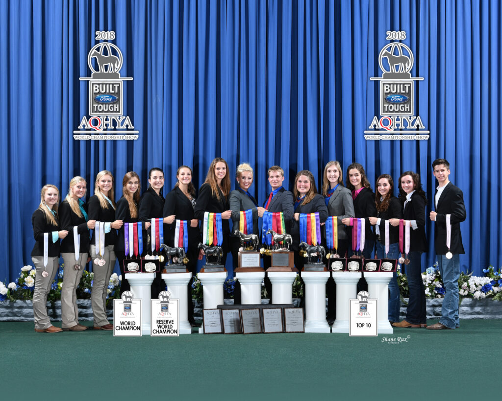 Horse Judging team standing for a picture with multiple awards and championships.